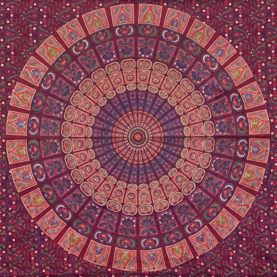 Close detail of hand block printed coral and dusty rose tiles on deep maroon cotton