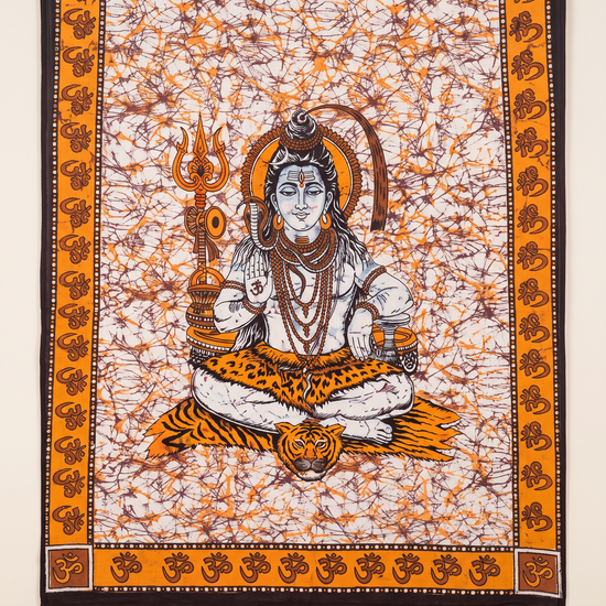 Close detail of the meditating Shiva figure on amber batik cotton